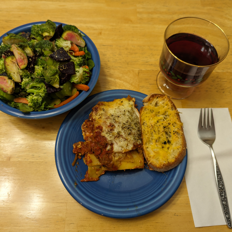Lasagna, salad, and garlic bread